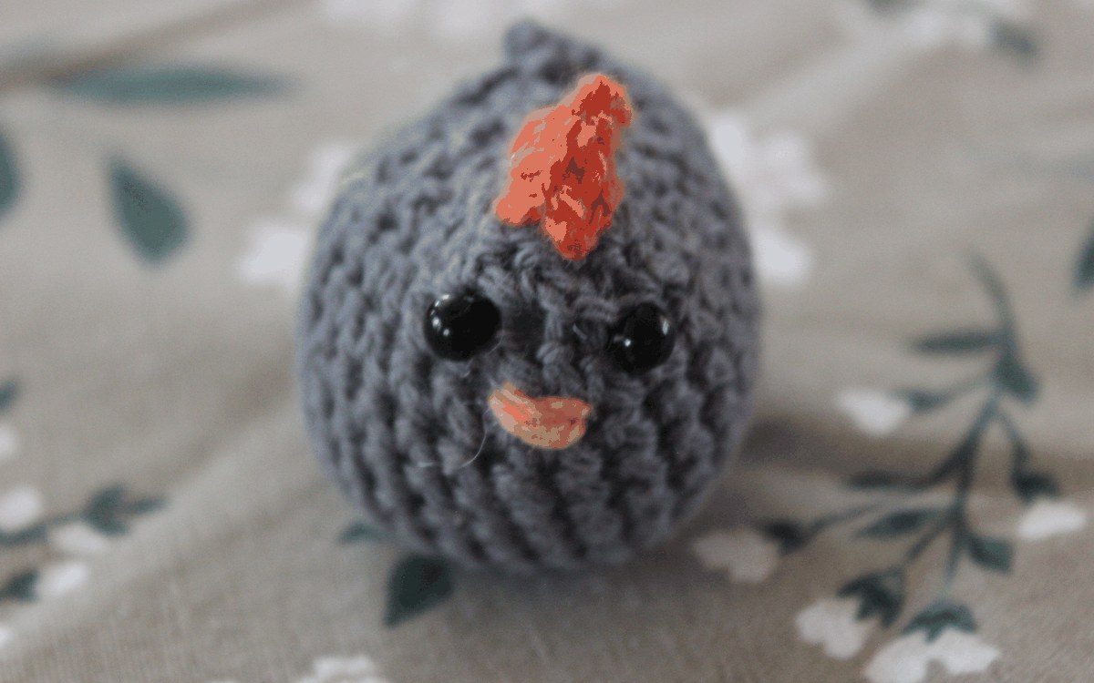 Small gray crocheted chicken