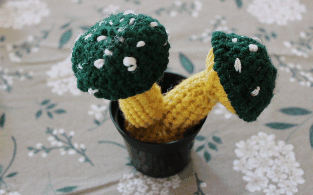 Pair of green spotted crocheted mushrooms